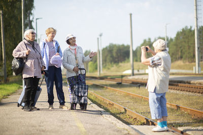 Rear view of people photographing at camera