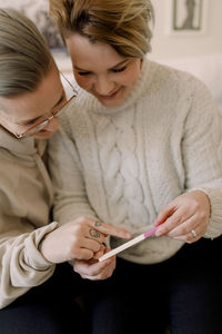 Curious lesbian couple looking at pregnancy test results