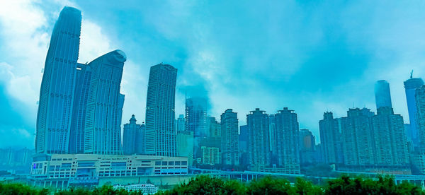 Panoramic view of buildings in city against sky