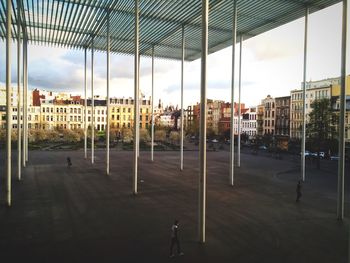 Buildings in city against cloudy sky