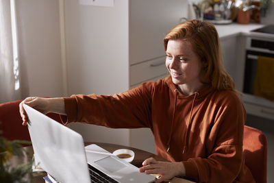 Woman using laptop at home