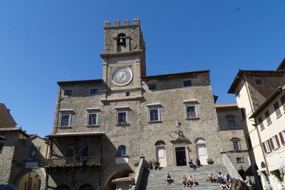 Low angle view of historic building against blue sky