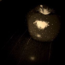 Close-up of illuminated lights over black background