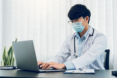 Young woman using laptop at office