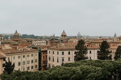 Buildings in city against clear sky