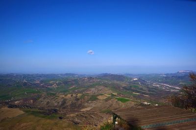 Scenic view of landscape against blue sky