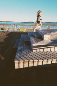 Woman on beach against clear sky