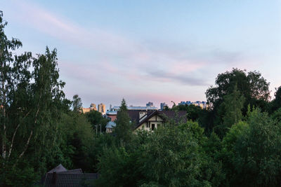 High angle view of trees and buildings against sky