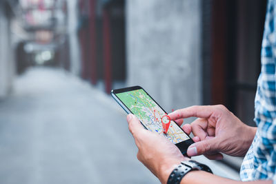 Midsection of woman using mobile phone