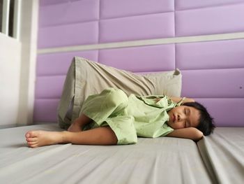 Young woman sleeping on bed