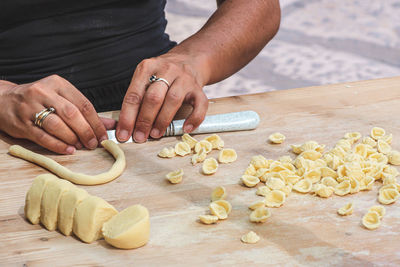 Midsection of woman preparing food on cutting board