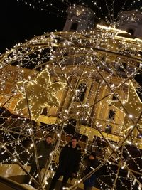 Man and illuminated lights at night