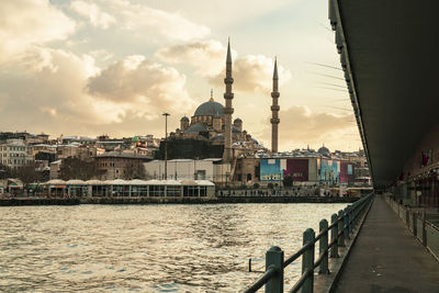 River amidst buildings against sky in city