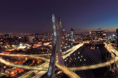 High angle view of illuminated buildings against sky at night