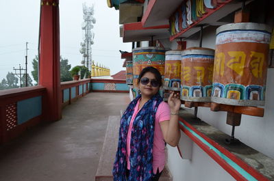 Portrait of woman standing at temple