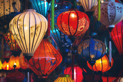 Low angle view of illuminated lanterns hanging in market at night