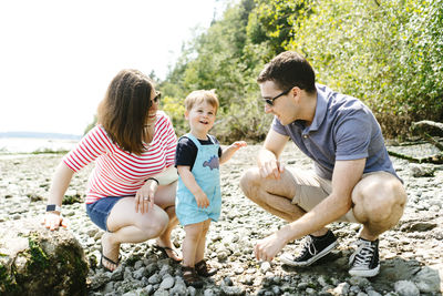 Straight on portrait of a family together on a rocky beach