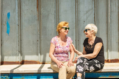 Two elderly women are happy to meet each other