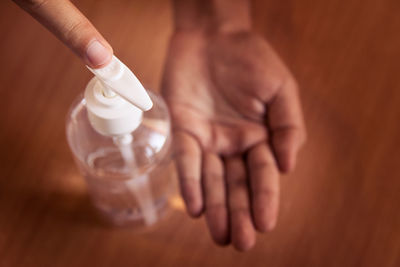 Midsection of person holding bottle