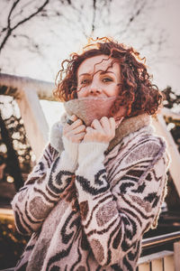 Close-up portrait of young woman in winter