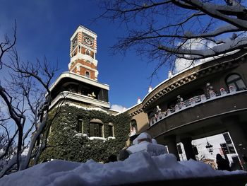 Low angle view of building against sky during winter