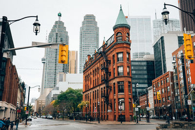 Street amidst buildings in city against sky