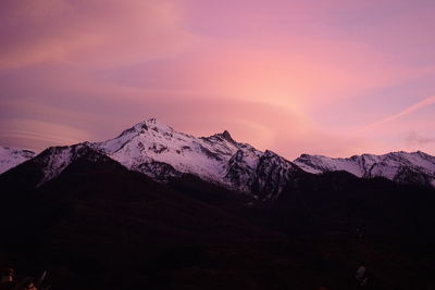 Scenic view of snowcapped mountains against sky during sunset