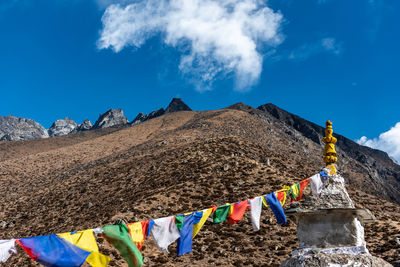 Low angle view of flags against blue sky