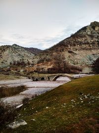 Scenic view of river amidst mountains against sky