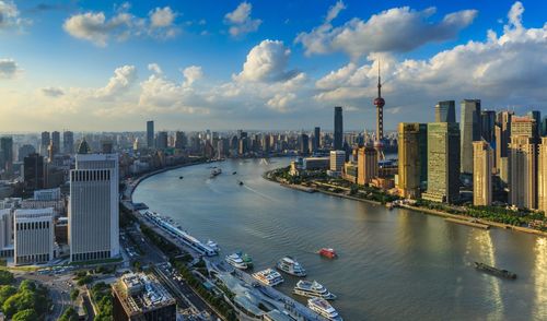 River amidst modern city against sky