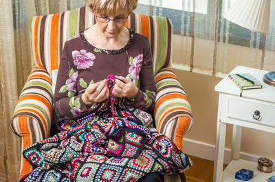 Mid adult woman sitting at home