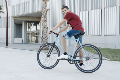 Young disabled cyclist riding bike in city