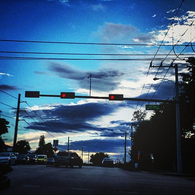 power line, sky, electricity pylon, transportation, car, street, cloud - sky, electricity, power supply, road, cable, land vehicle, street light, mode of transport, power cable, building exterior, cloud, built structure, cloudy, tree