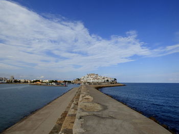 Footpath leading towards castillo de peniscola against sky