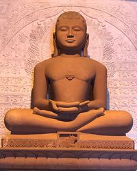 Statue of buddha against wall