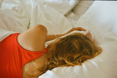High angle view of woman lying on bed at home