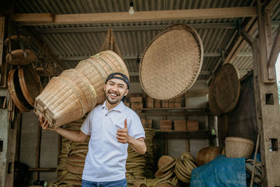 Rear view of man standing in wicker basket