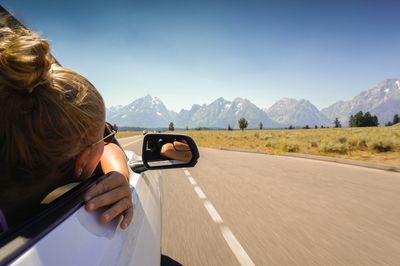 Woman looking through car window