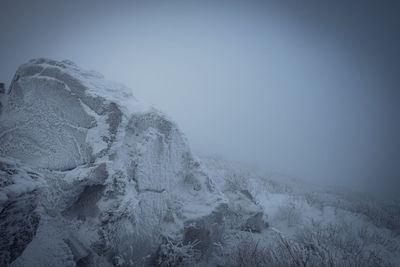 Scenic view of snowcapped mountains against sky during winter