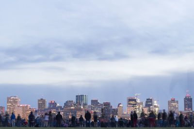 View of cityscape against cloudy sky