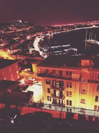 High angle view of illuminated buildings in city at night