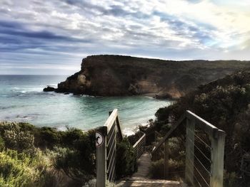 High angle view of steps by sea against sky