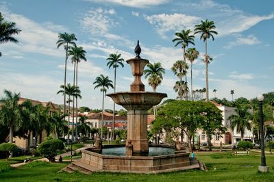 View of fountain in park against sky