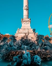 Low angle view of statue against blue sky