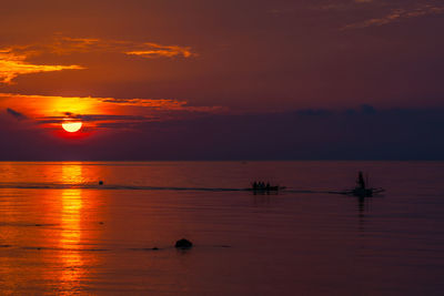 Scenic view of sea against orange sky