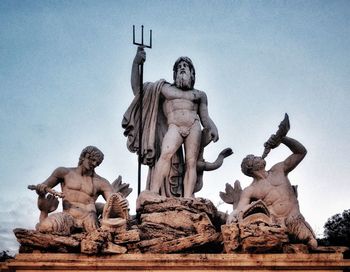 Low angle view of angel statue against sky