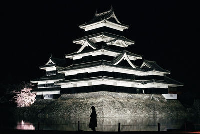 Low angle view of illuminated building against sky at night