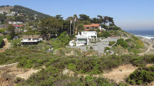 Scenic view of sea and buildings against sky