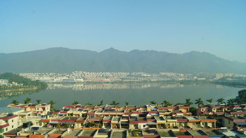 High angle view of townscape by mountains against clear sky