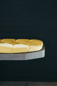 Close-up of bread on table against black background